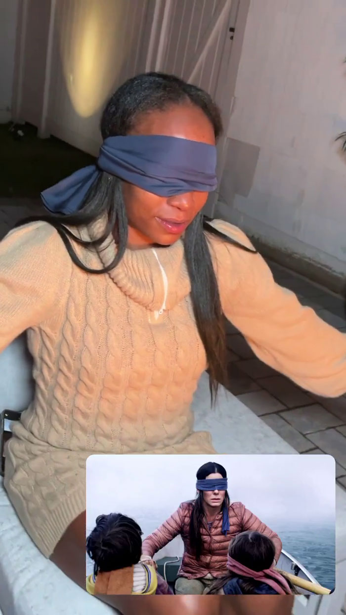 Meme-themed party guest wearing a blindfold, mimicking a popular meme scene with two children in a boat.