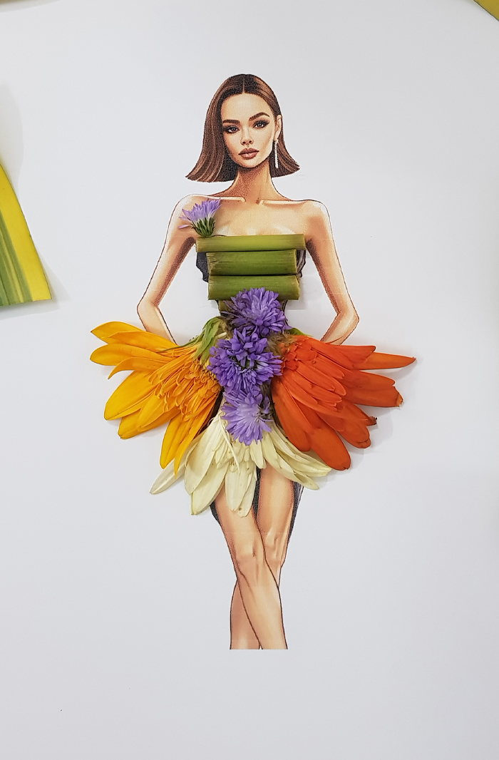 A drawing of a woman dressed in real flower petal gown