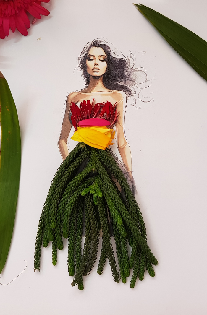 A drawing of a woman dressed in real flower petal gown