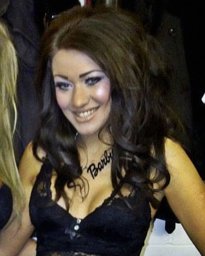 Smiling woman with long dark hair and a necklace, showing style before being recognized as Britain's most tattooed woman. Smiling woman with long dark hair and a necklace, showing style before being recognized as Britain's most tattooed woman.