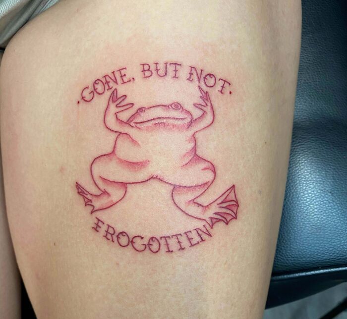 Frog tattoo with "Gone, but not forgotten" text, honoring family.