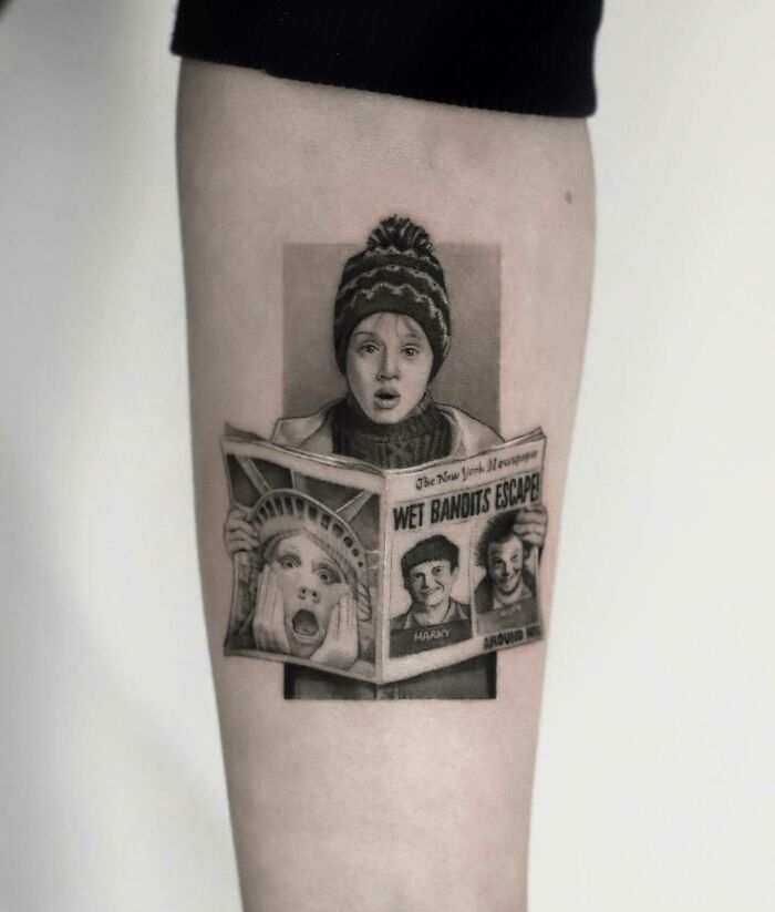 Tattoo of a child in winter attire reading a newspaper, inspired by ‘90s culture.