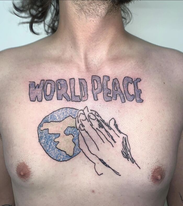 Chest tattoo of "World Peace" with Earth and praying hands, representing a questionable tattoo choice.