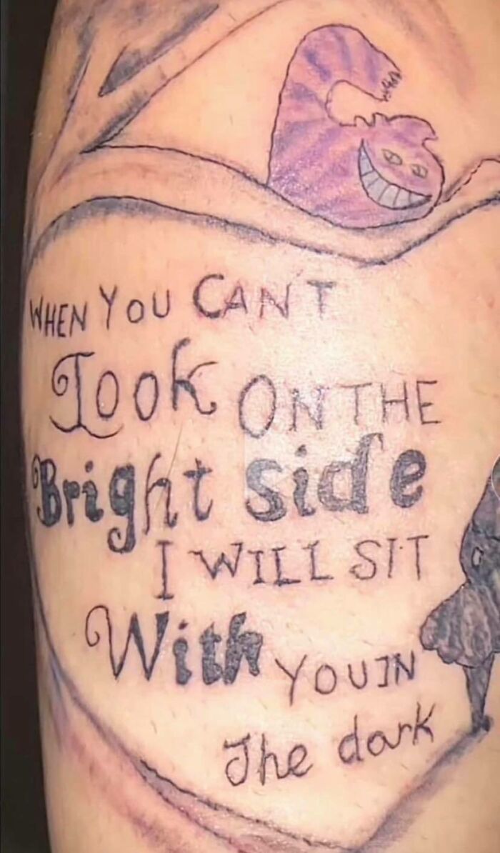 Tattoo with "When you can't look on the bright side" text and a Cheshire Cat drawing, representing a worst tattoo choice.