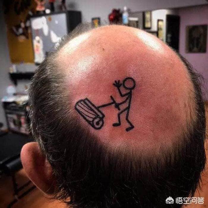 Bald man's head with stick figure tattoo rolling a lawn roller, one of the worst tattoos.