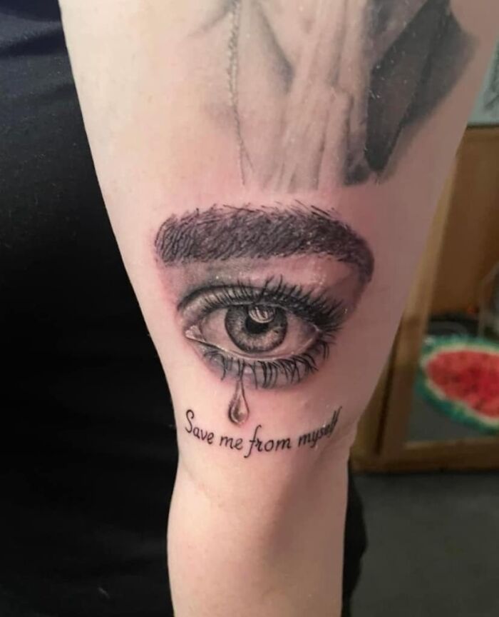 Tattoo of a crying eye with the words "Save me from myself" on an arm. Worst tattoos collection.