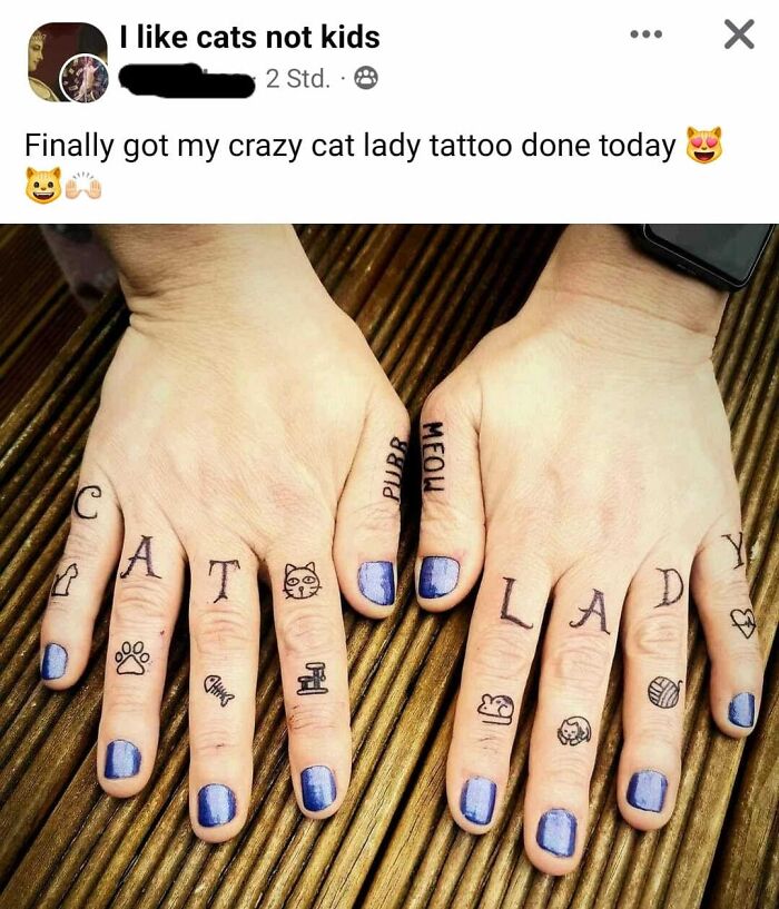 Tattoos on fingers spelling "CAT LADY" with cat-themed designs, featuring blue nail polish.