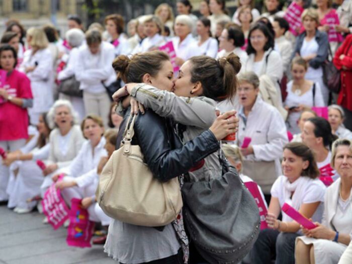 Two Girls Kissing In Front Of An Anti-Gay Protest