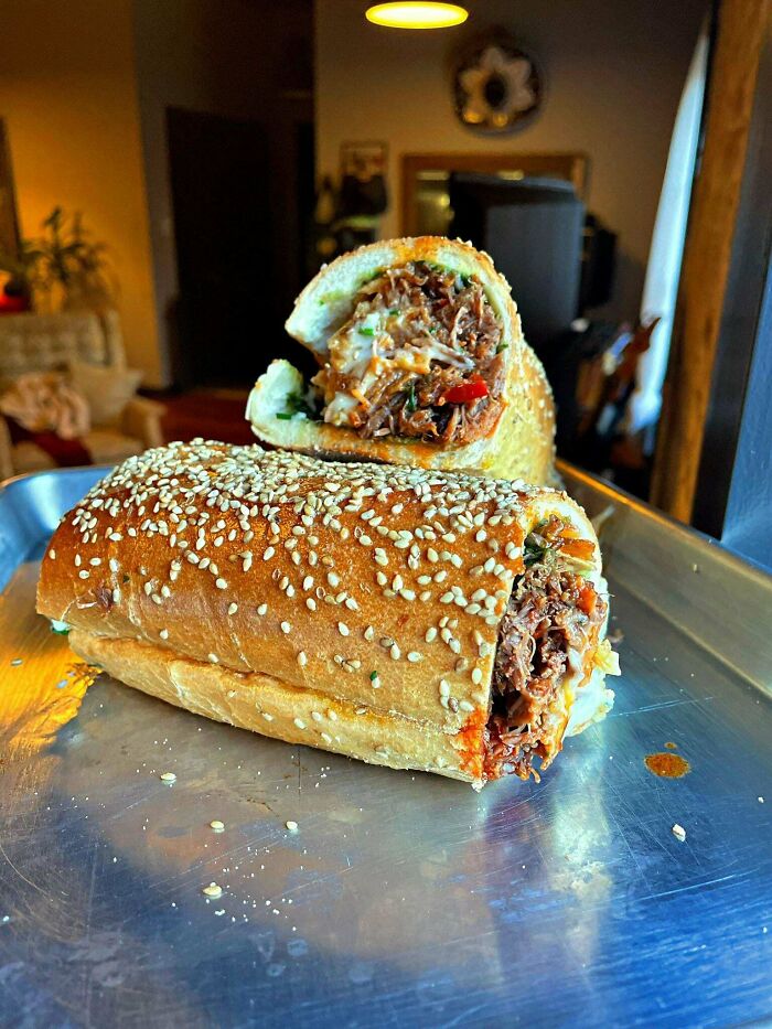 Pulled Braised Short Rib In Arrabiata And Calabrian Chilis, Parmigiano Reggiano And Garlic Whiz, Basil Gremolatta, Frenchs Crispy Fried Onions, And Chives Sarcones Seeded Roll