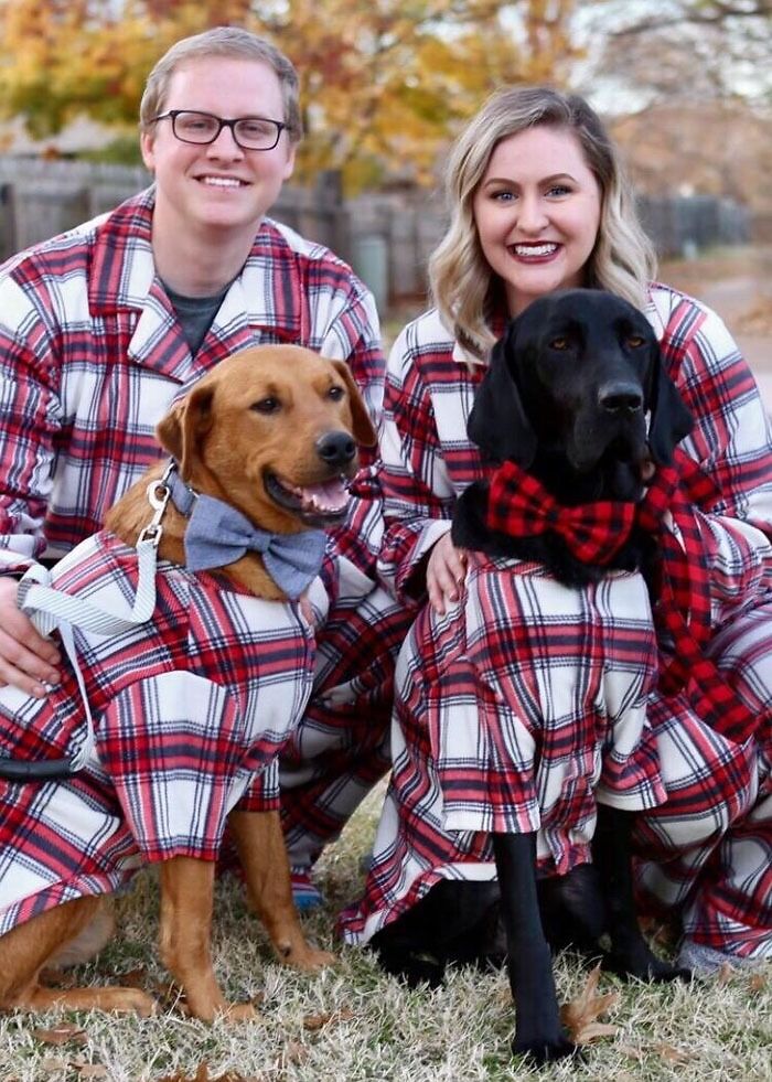 A couple and their two dogs wearing matching plaid pajamas and bow ties, showcasing gifts for pets and humans.