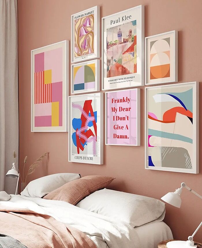 Bedroom with gallery wall featuring colorful and modern bedroom wall decor ideas in a cozy pink-toned space.