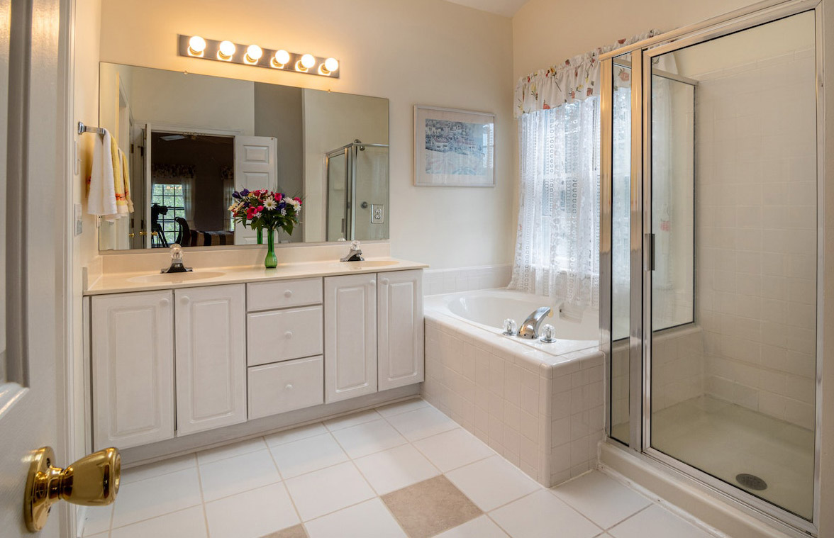 Bathroom with warm toned lights over the mirror