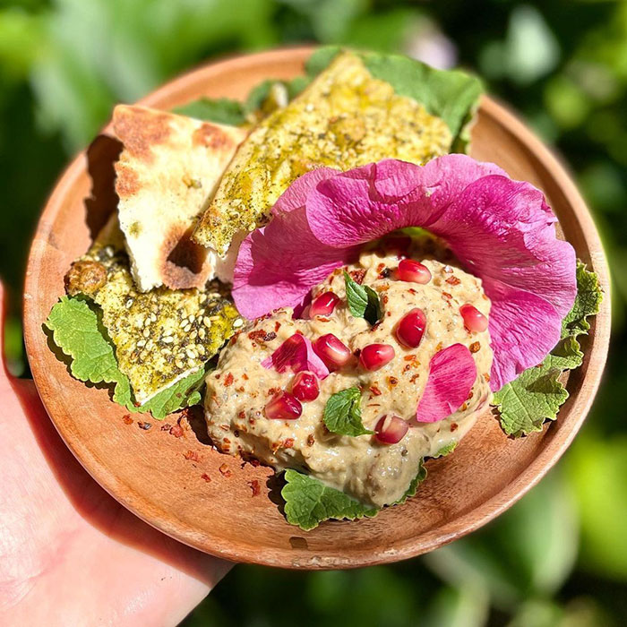 A dish with a hollyhock flower.