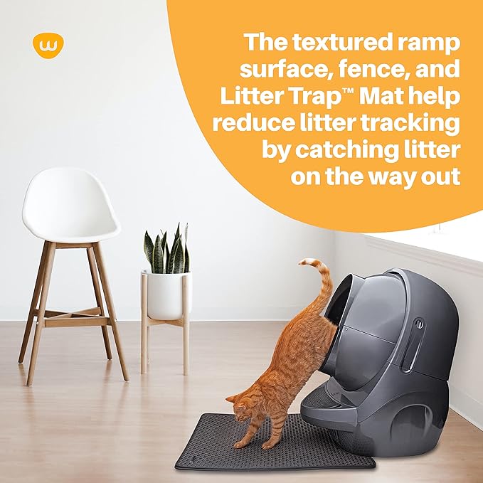 Cat exiting a modern litter box onto a mat designed to keep dogs out.