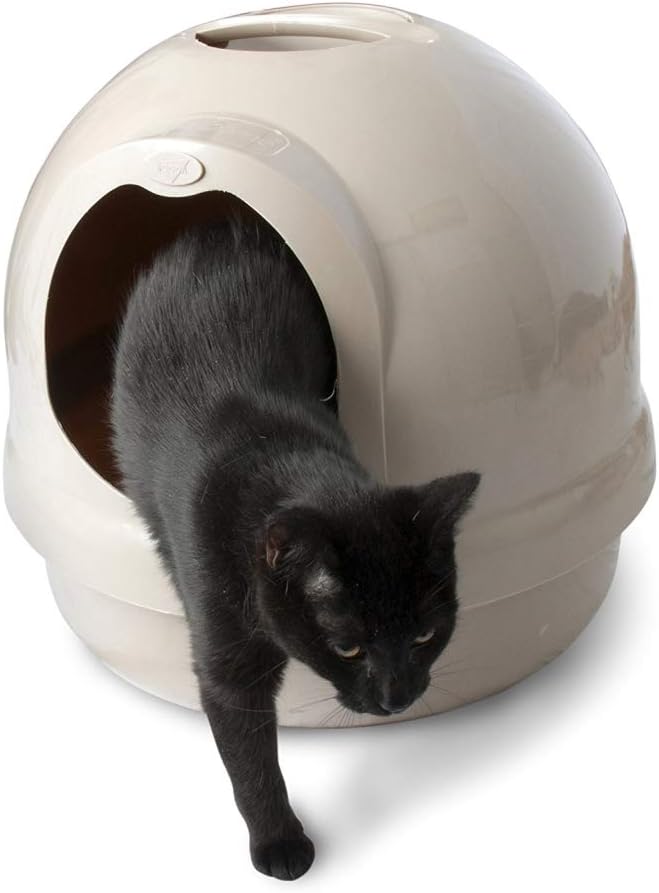 Black cat exiting a dome-shaped litter box.