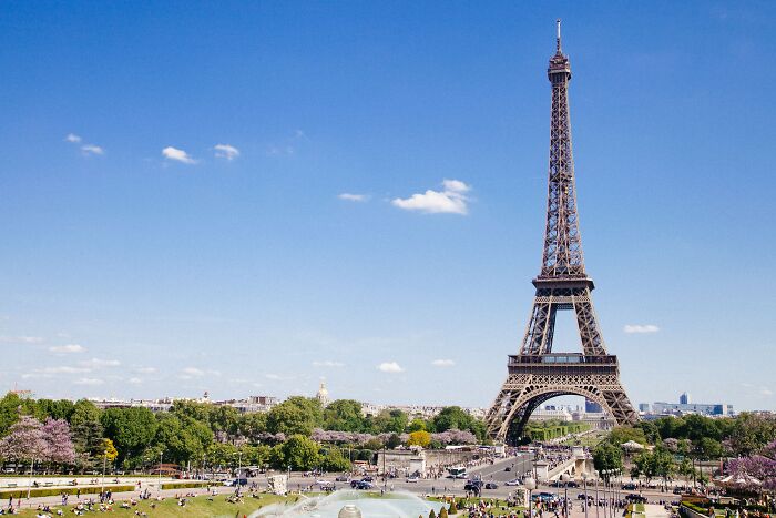 Eiffel Tower in Paris with clear skies and crowds, highlighting cultural landmarks in popular countries around the world.
