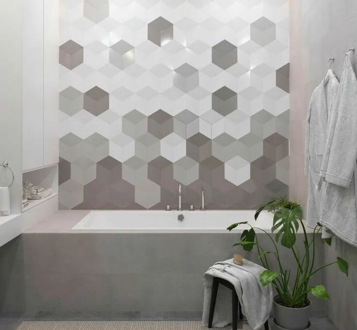 Bathroom with hexagon tile design in varying gray shades covering the wall behind the bathtub for stylish flooring and walls.