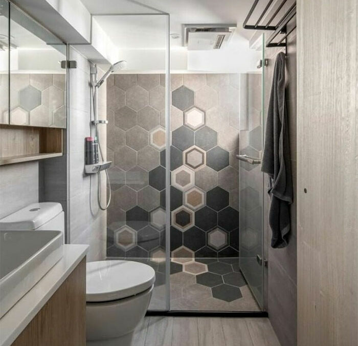 Modern bathroom featuring hexagon bathroom tile design ideas on walls and flooring with a toilet and sink.
