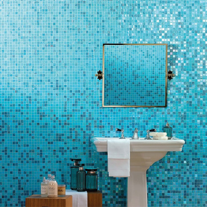 Bathroom with blue mosaic tile wall and sink showcasing beautiful bathroom tile design ideas for walls and flooring.