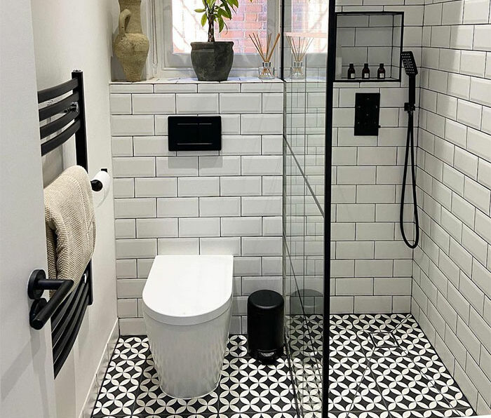 White bathroom featuring checkerboard patterned tile flooring and clean white subway tile walls for stylish bathroom tile design ideas.
