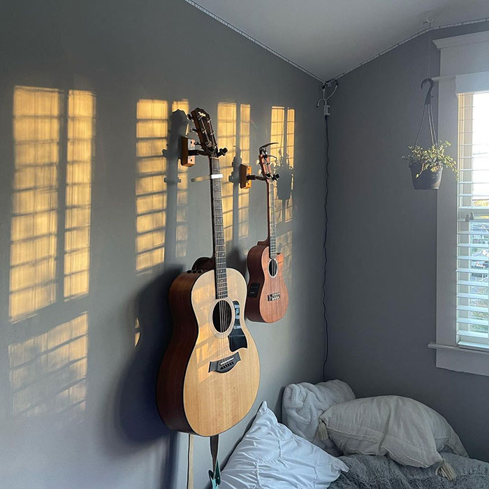 Acoustic guitars hanging on a bedroom wall showcasing cool and inspiring bedroom wall decor ideas.
