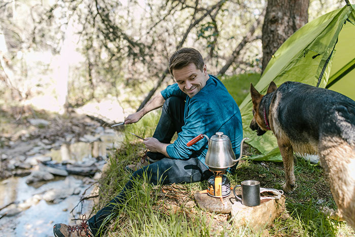 Smiling Man Looking at His Pet Dog