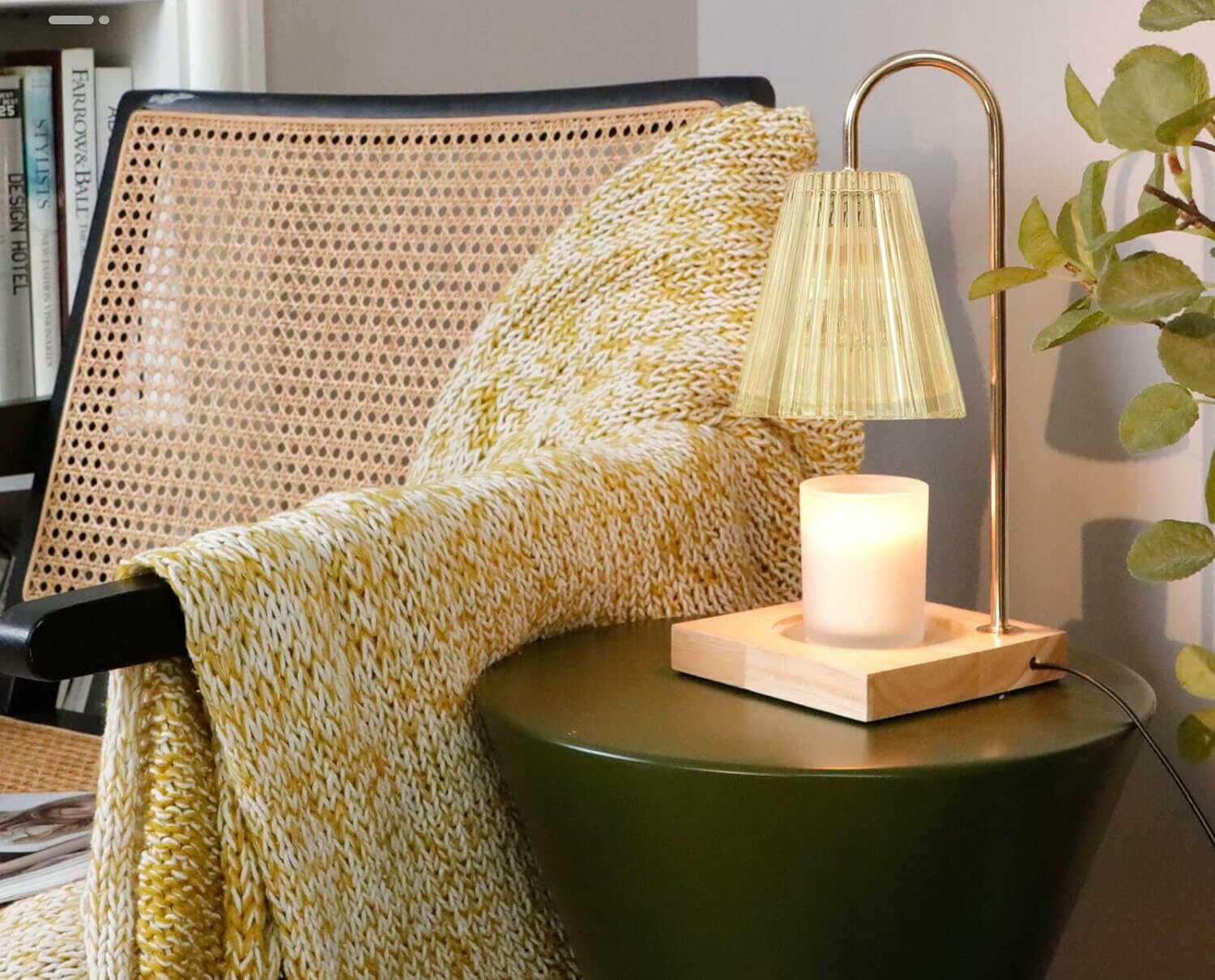 glass candle warmer on green table near chair