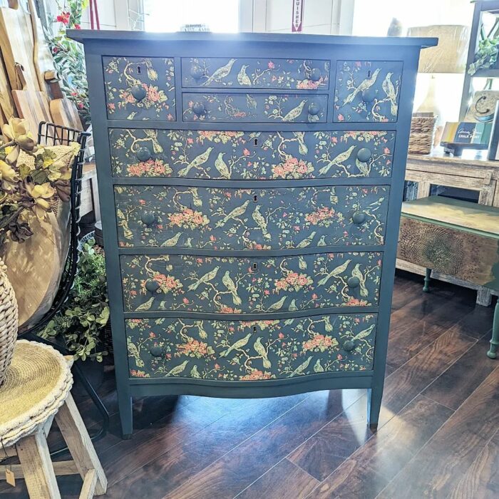 A blue chalk-painted dresser with flowers and bird designs A blue chalk-painted dresser with flowers and bird designs