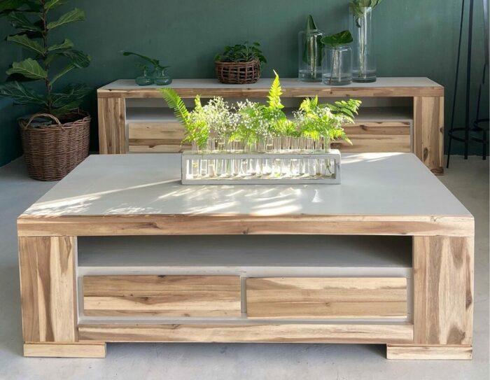A chalk-painted wooden table with plants on it A chalk-painted wooden table with plants on it