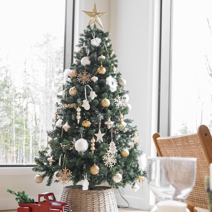 Red toy car under beautifully decorated Christmas tree featuring magical Christmas tree decorations.