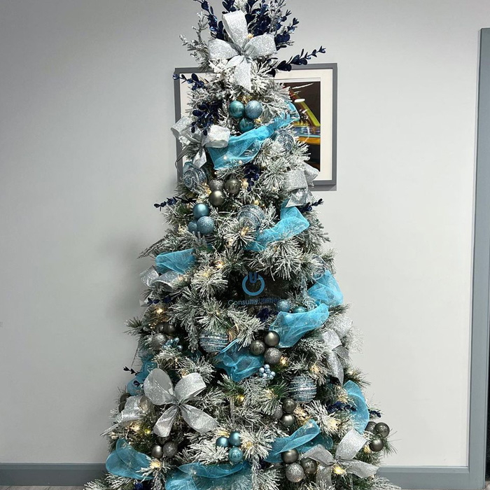Christmas tree decorated with baby blue and silver ornaments featuring ribbons and frosted branches for magical Christmas tree decorations.