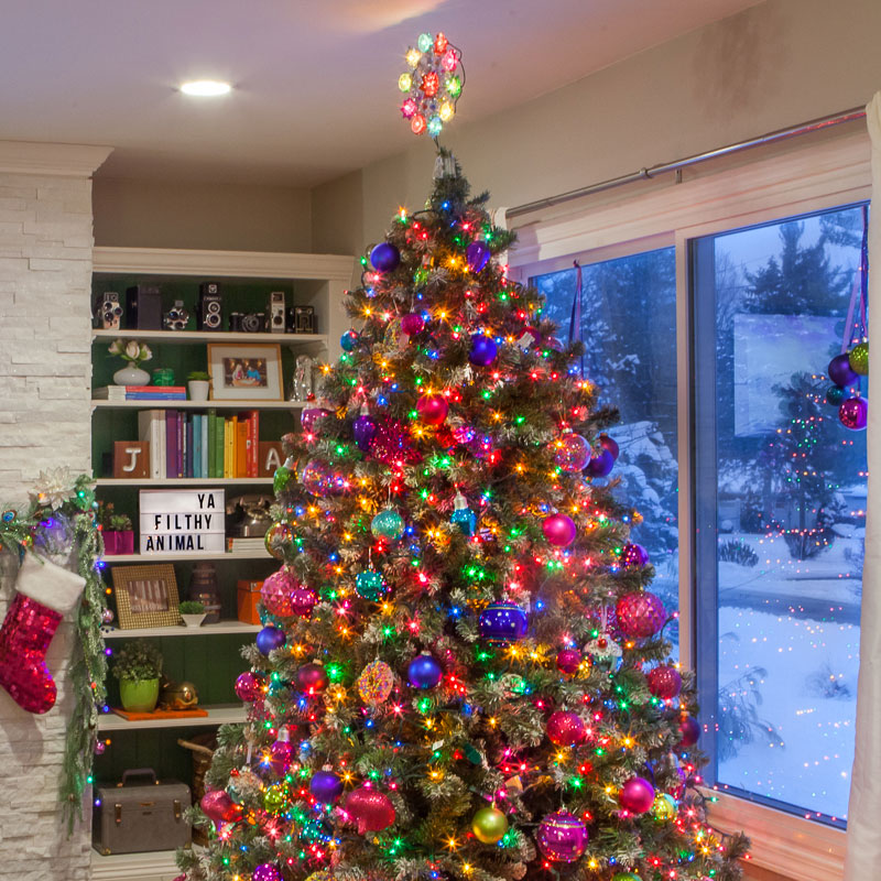Decorated Christmas tree with colorful string lights and vibrant ornaments for magical Christmas tree decorations.