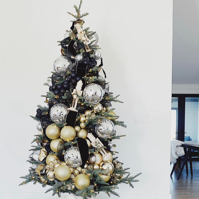 Christmas tree decorated with silver disco balls and gold ornaments for magical Christmas tree decorations and ideas.