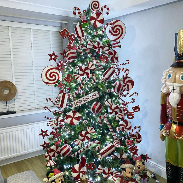 Christmas tree decorated with candy cane ornaments and red and white festive decorations for magical celebrations.