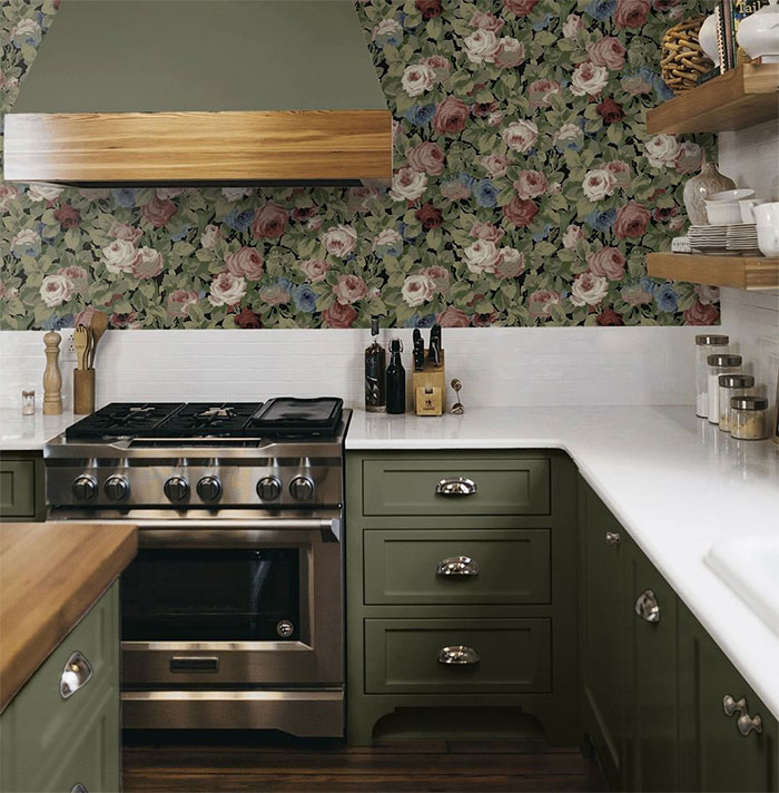 Country kitchen with green cupboards and flower wallpaper