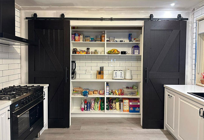 Double black barn doors in the kitchen