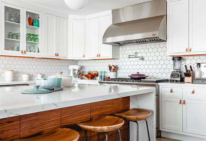 Modern country kitchen with white hexagon tiles and marble wooden table