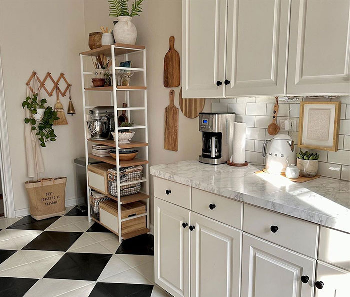 Country kitchen with checkered flooring and white cupboards