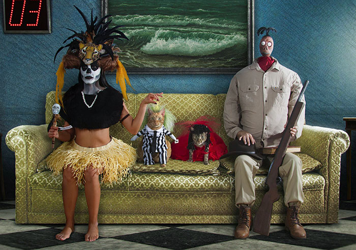 Creative Halloween costumes featuring unique masks, props, and themed outfits in a vintage living room setting.