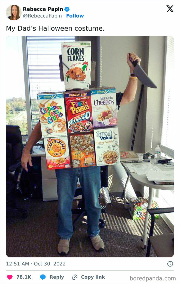Man in clever Halloween costume made of cereal boxes holding a prop knife in an office setting.