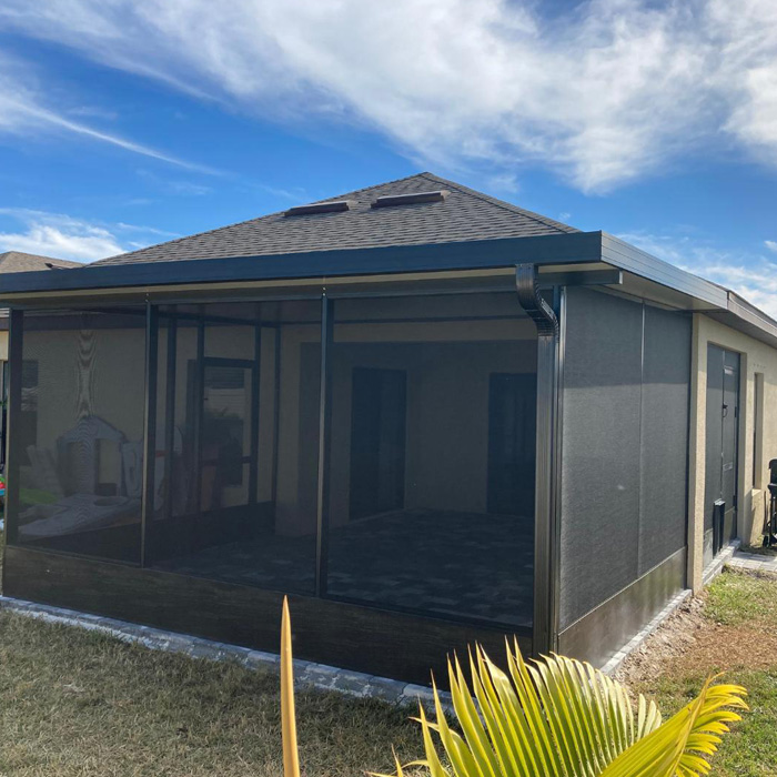 Screened backyard deck with bug protection and shaded outdoor space for relaxing and enjoying time outdoors.