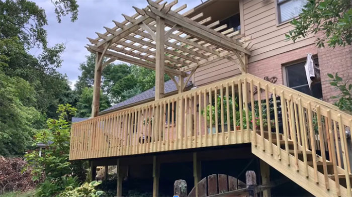 Wooden deck railing with pergola design enhancing outdoor space and adding style to exterior deck area