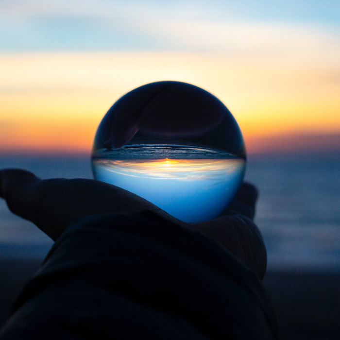 A person holding a glass ball 