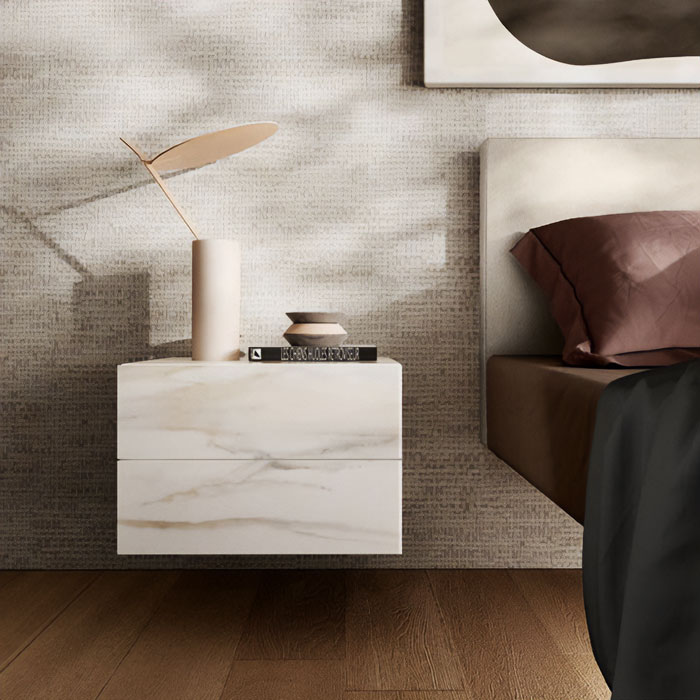 Marble floating nightstand with minimalist decor next to bed in a modern bedroom setting.