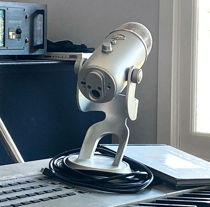 The Back Side Of This Studio Microphone Appears To Be Holding Its Head, Screaming In Pain