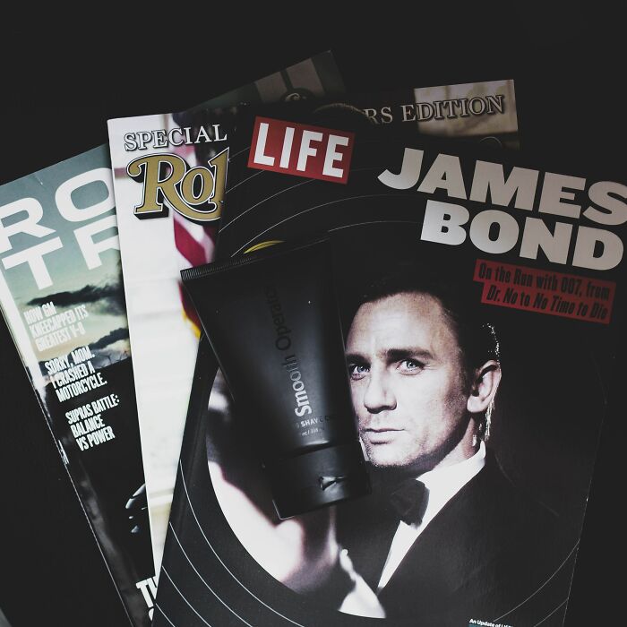 Shower thought question idea: A shaving cream tube on magazines, including a James Bond cover.