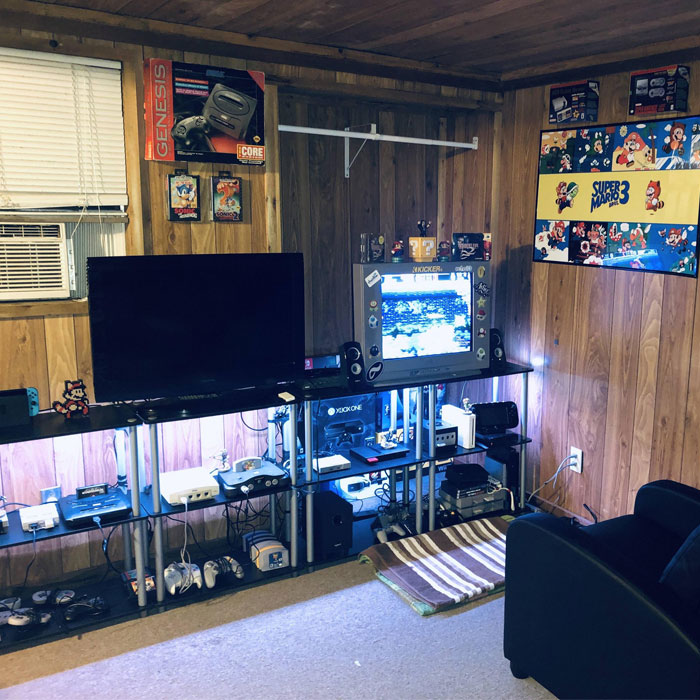 Lodge style wooden game room with multiple retro and modern consoles, TVs, and gaming decor for game room ideas. Lodge style wooden game room with multiple retro and modern consoles, TVs, and gaming decor for game room ideas.