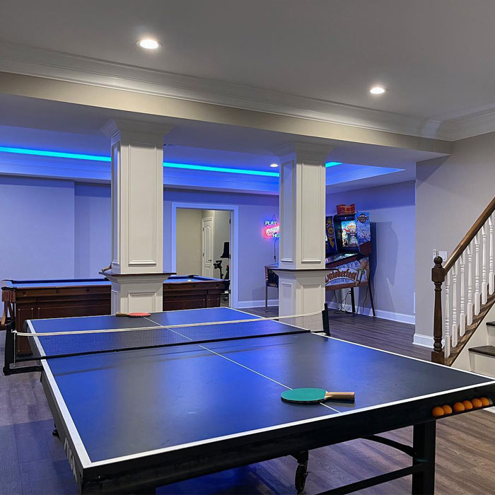 Bright game room with a ping-pong table, arcade machine, and pool table showcasing popular game room ideas. Bright game room with a ping-pong table, arcade machine, and pool table showcasing popular game room ideas.