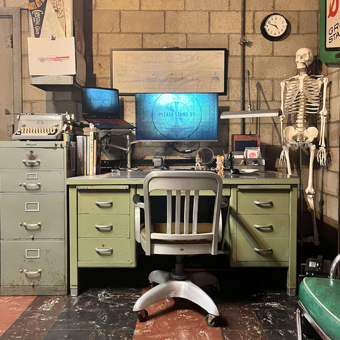 Retro game room ideas featuring vintage desk, typewriter, computer screens, and skeleton for unique gaming cave setup. Retro game room ideas featuring vintage desk, typewriter, computer screens, and skeleton for unique gaming cave setup.