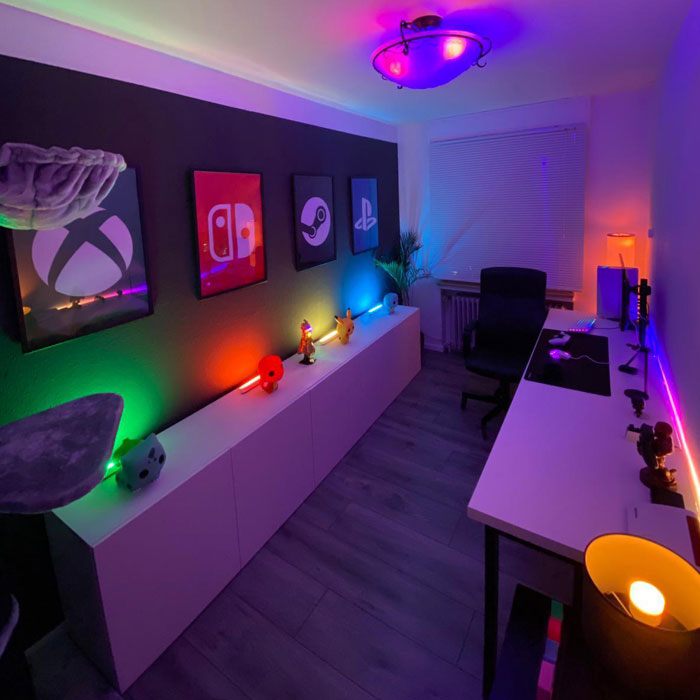 Small and simple game room featuring colorful LED lights and gaming decor for an immersive gaming cave experience. Small and simple game room featuring colorful LED lights and gaming decor for an immersive gaming cave experience.